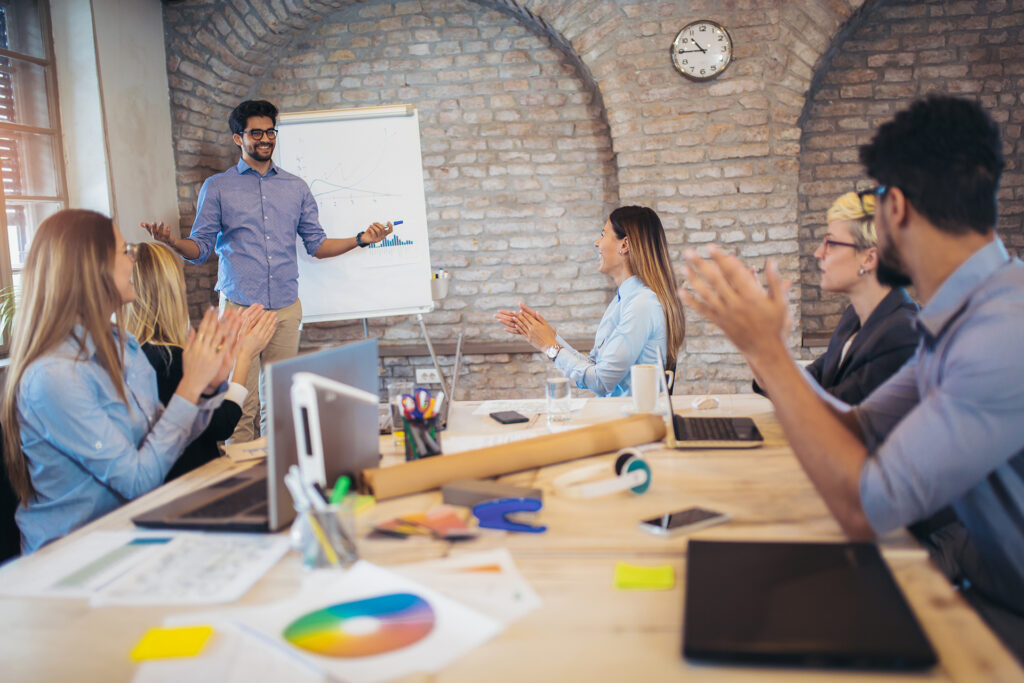 A group of employees engaged in a brainstorming session, developing fresh ideas for the company’s future