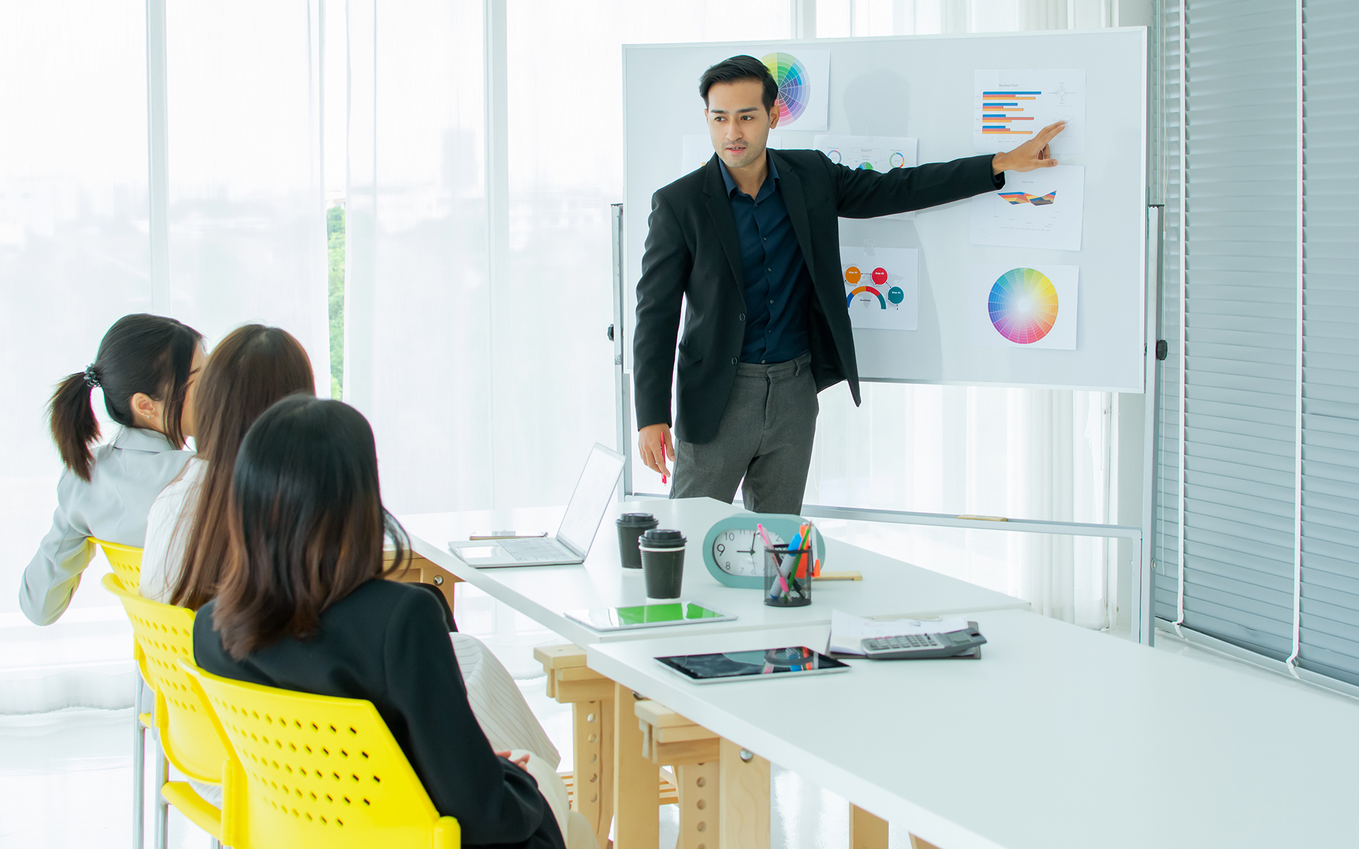 A leader guiding their team during a crisis or major change, with strategic diagrams or discussions in the background