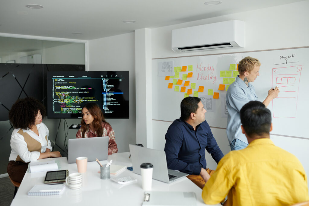 A team brainstorming ideas on a whiteboard, showcasing new strategies and solutions