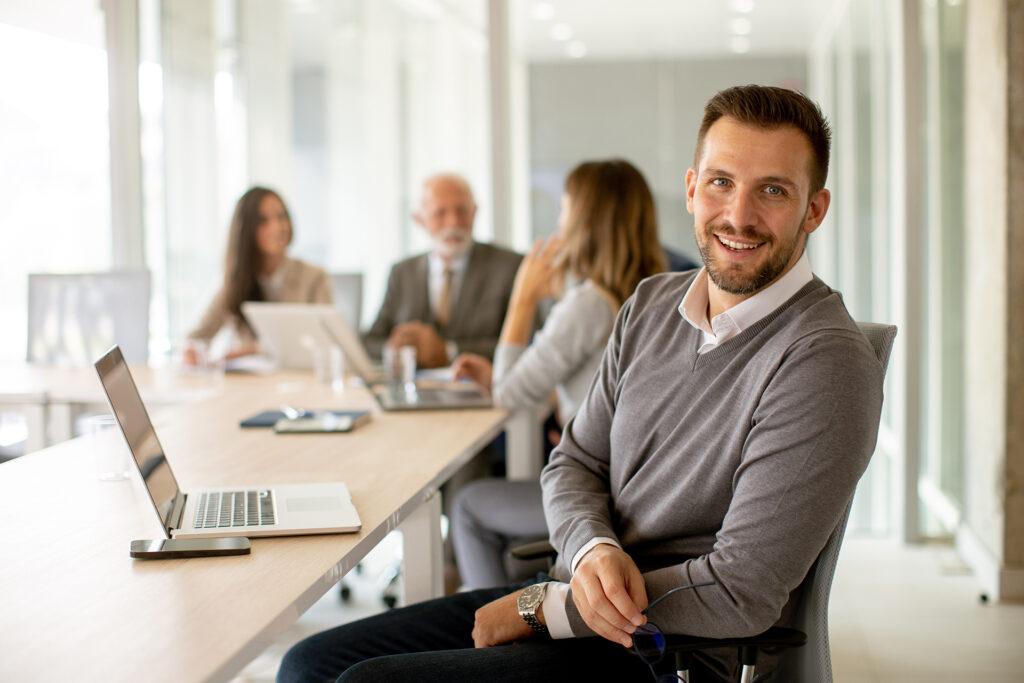 A team working harmoniously in a modern, well-lit office, exchanging ideas and collaborating on projects